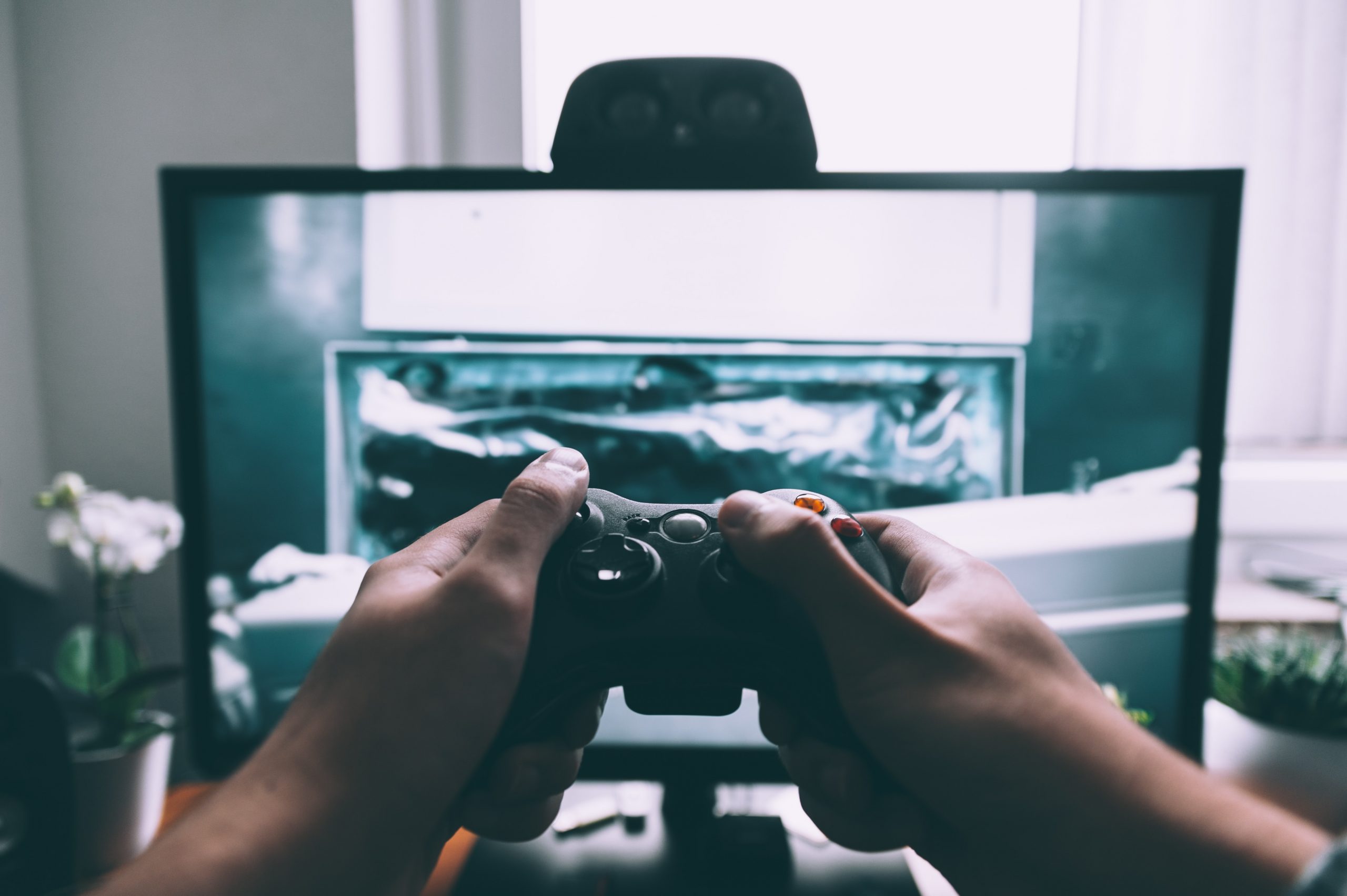 wallpaper Person holding game controller in-front of television