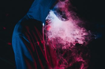 Man in black hoodie smoking