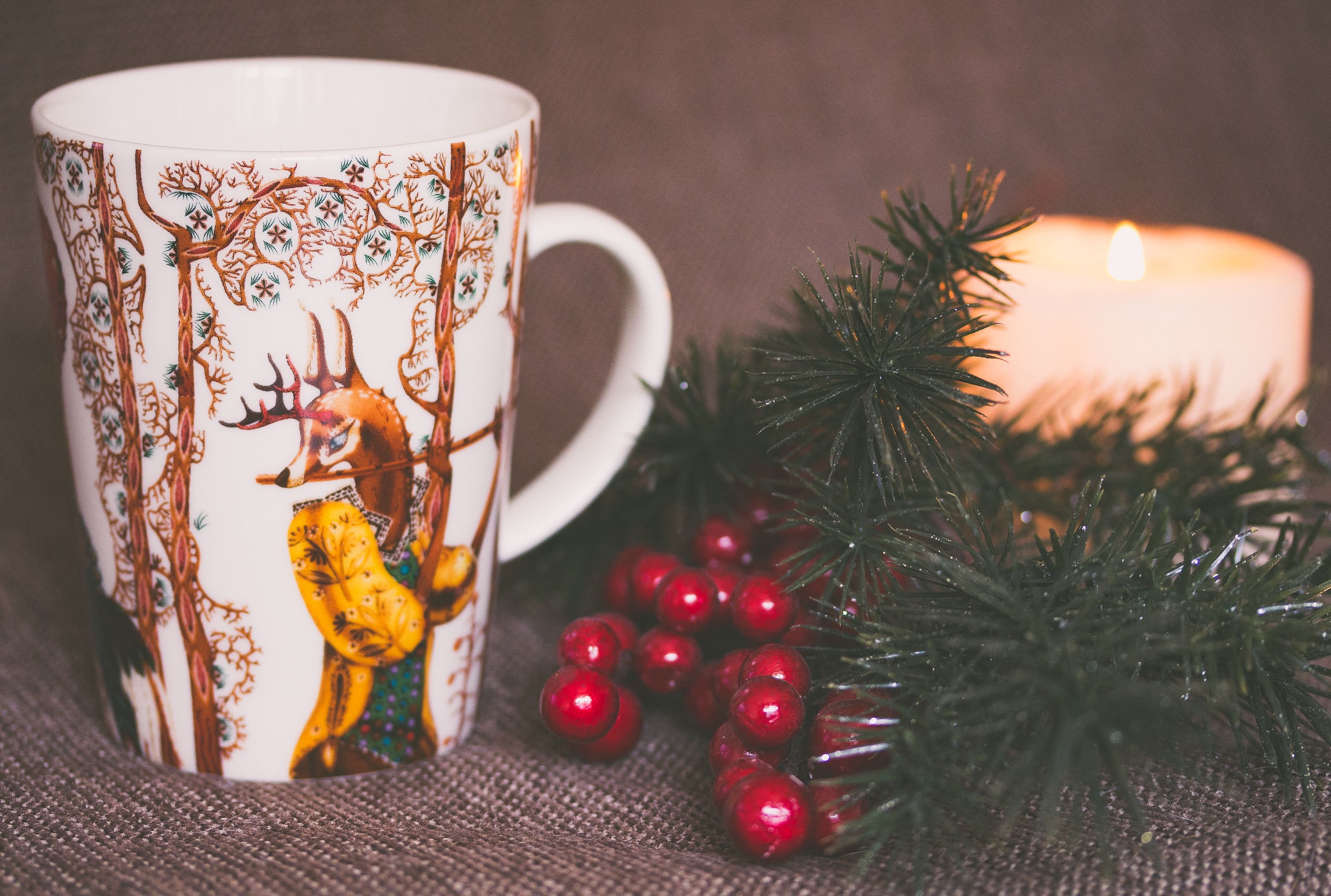 wallpaper White and brown print ceramic mug near red mistletoe and candle