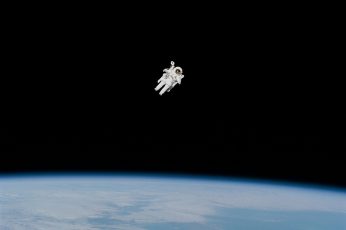 Astronaut in spacesuit floating in space