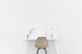 White wooden table near brown chair