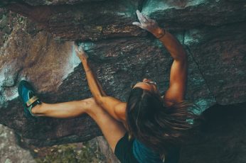 Woman climbing mountain