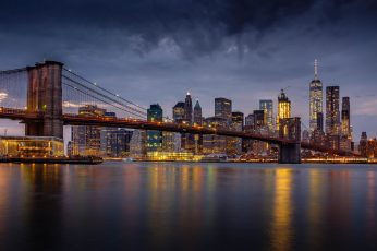 Photography of black concrete bridge and city building during night time wallpaper