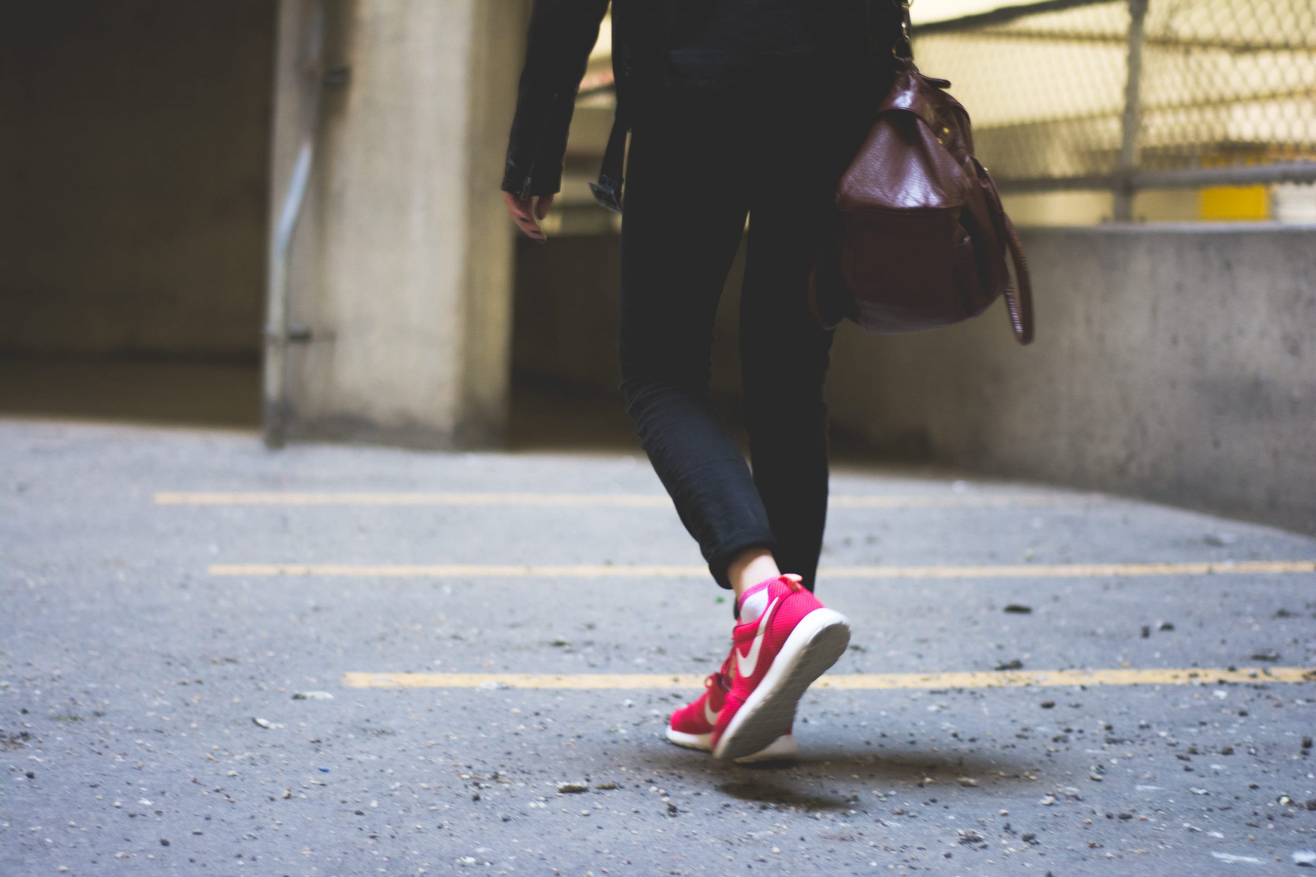 Wallpaper person wearing Nike running shoes walking along the path, woman walking on road near fence