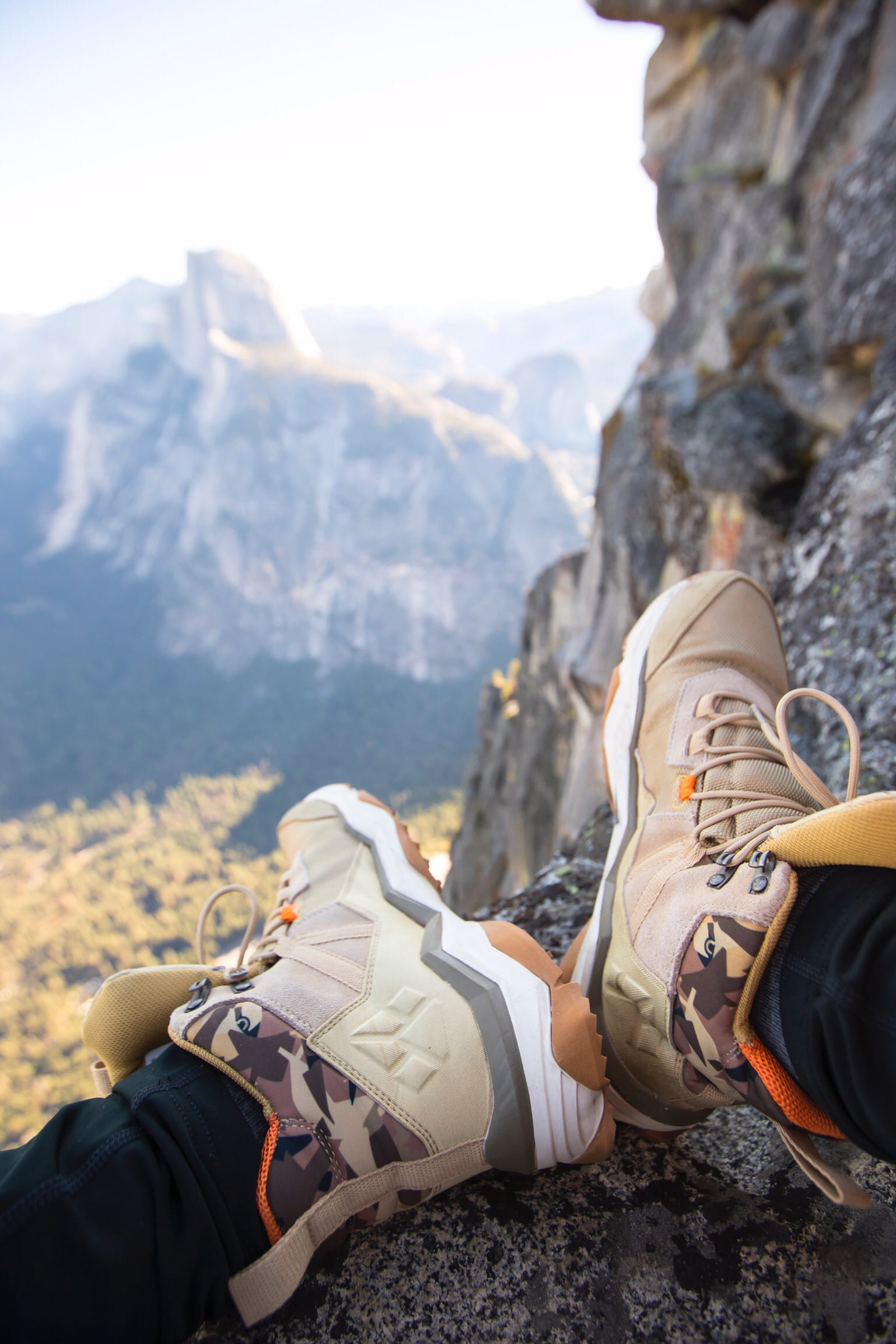 Wallpaper person sitting on rock near gray fault-block mountain, shoe, apparel