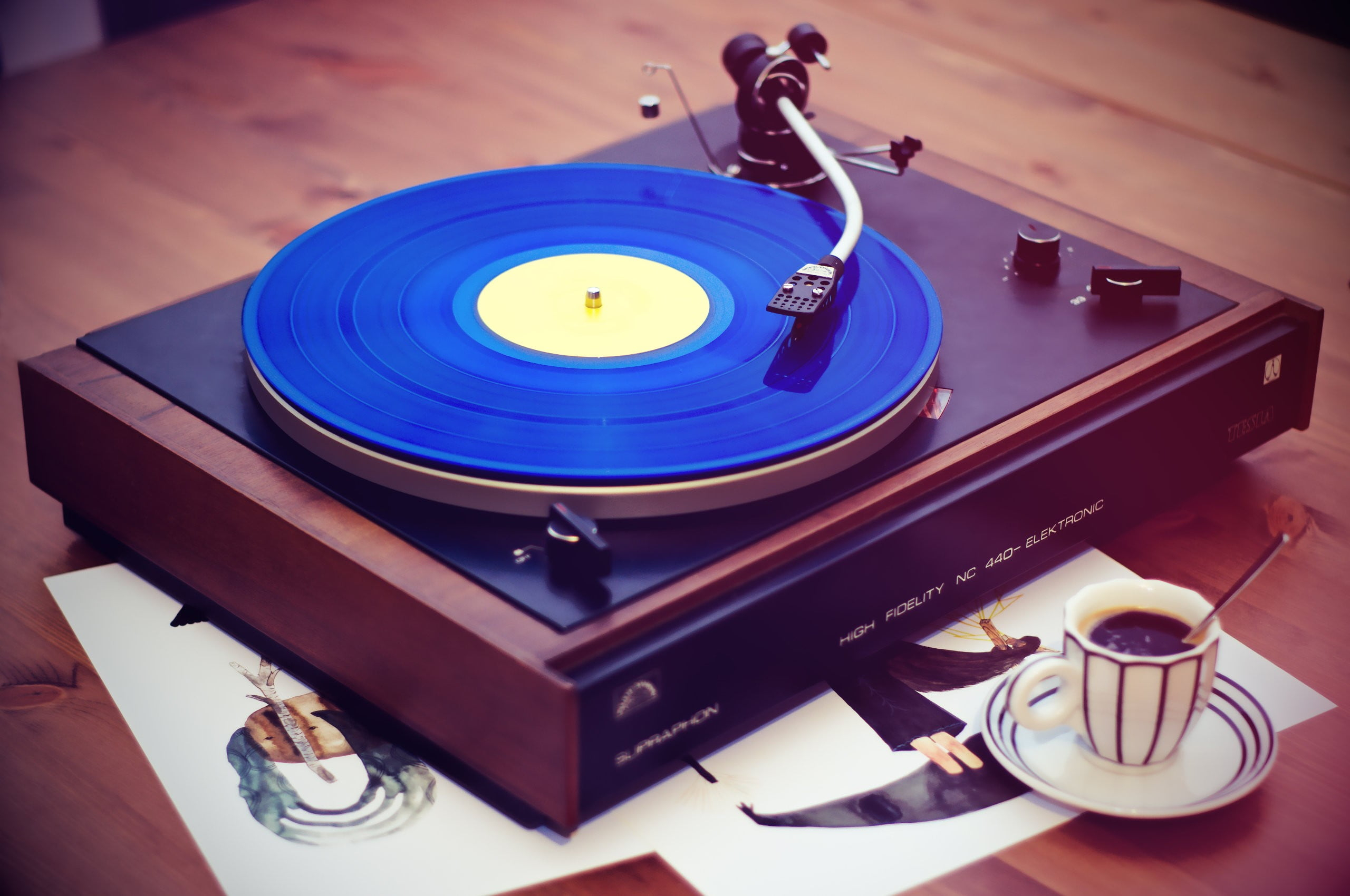 Black, brown, and blue vinyl record player, vintage wallpaper, coffee, music