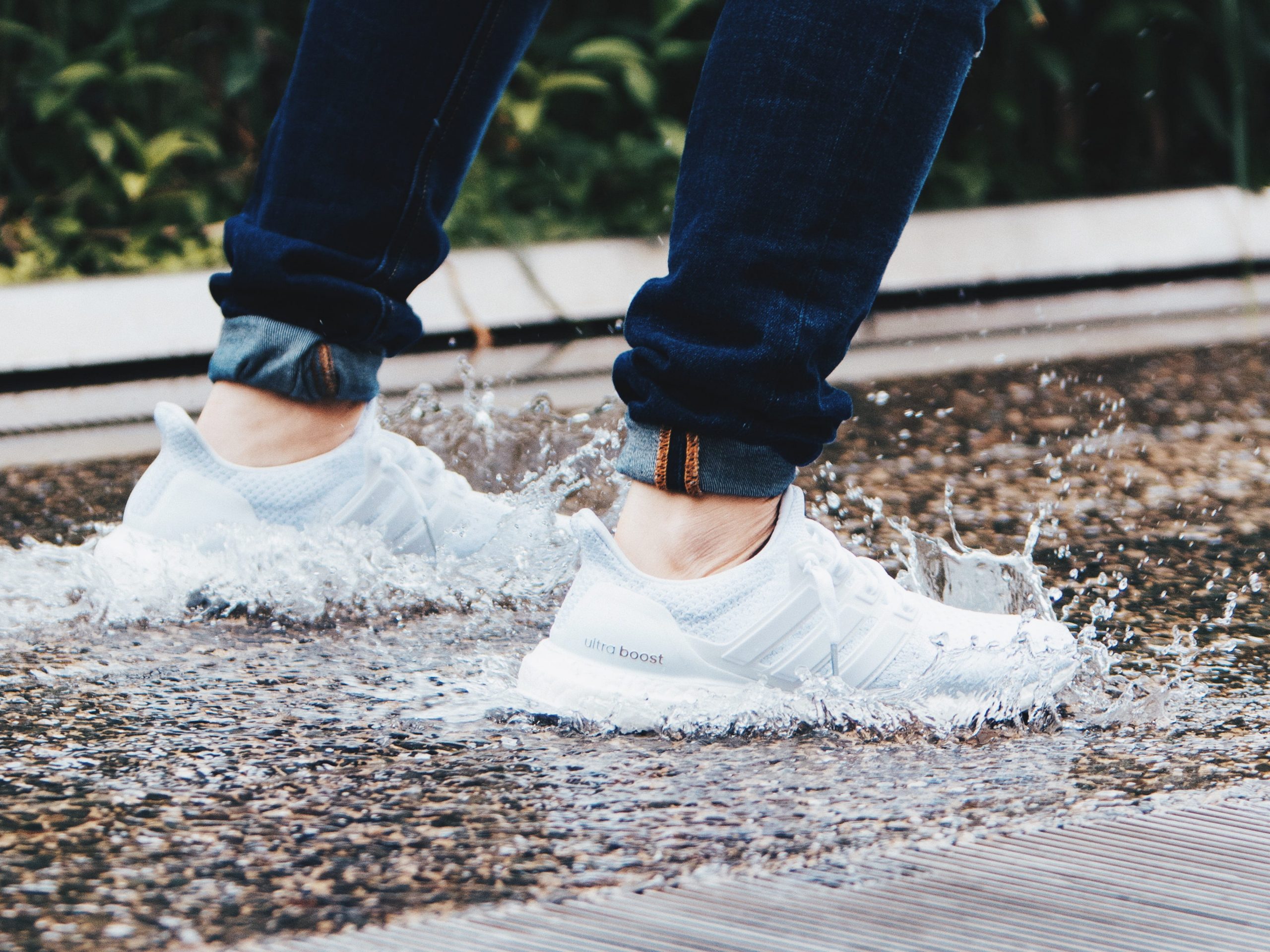 Wearing pair of gray adidas UltraBOOST low-top sneakers stepped on pool of water wallpaper, Sneakers, Empty