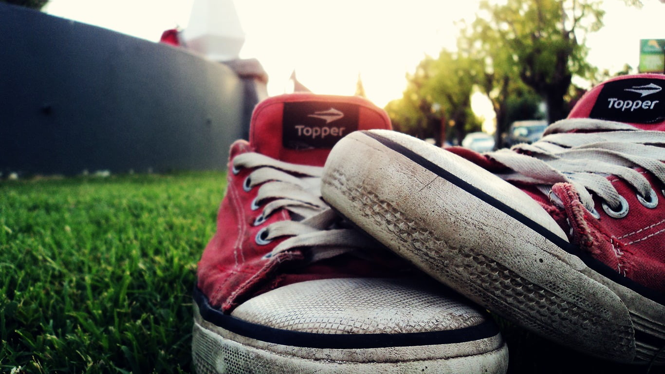 Pair of red-and-white Topper low-top sneakers wallpaper, shoes, grass, focus on foreground