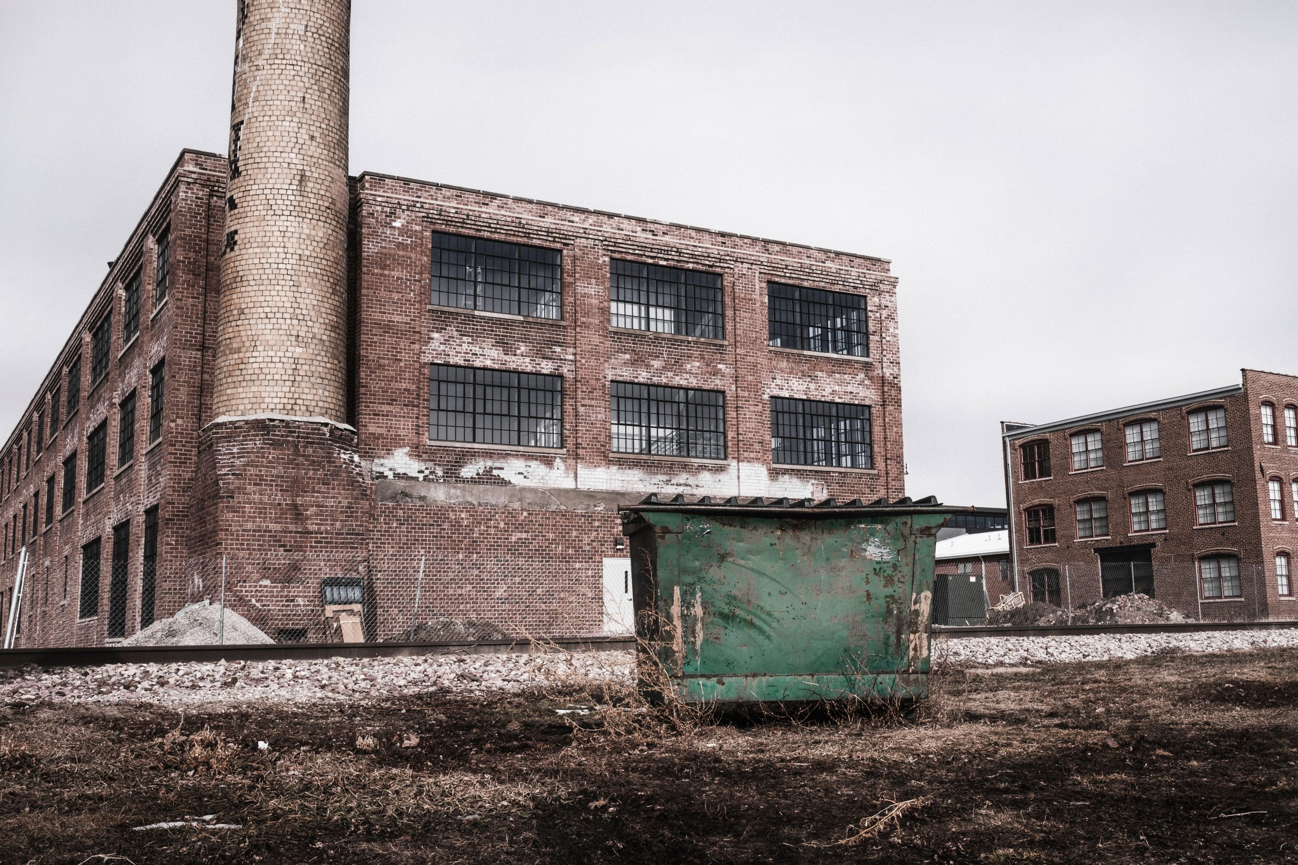 Green garbage bin near building at daytime wallpaper, urban, lazy, factory