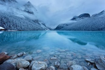 Landscape photography of gray stone in body of water during cloudy season