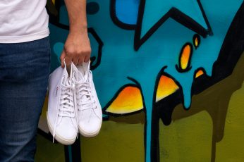 White shoes next to graffiti wall, clean, williamsburg, art wall