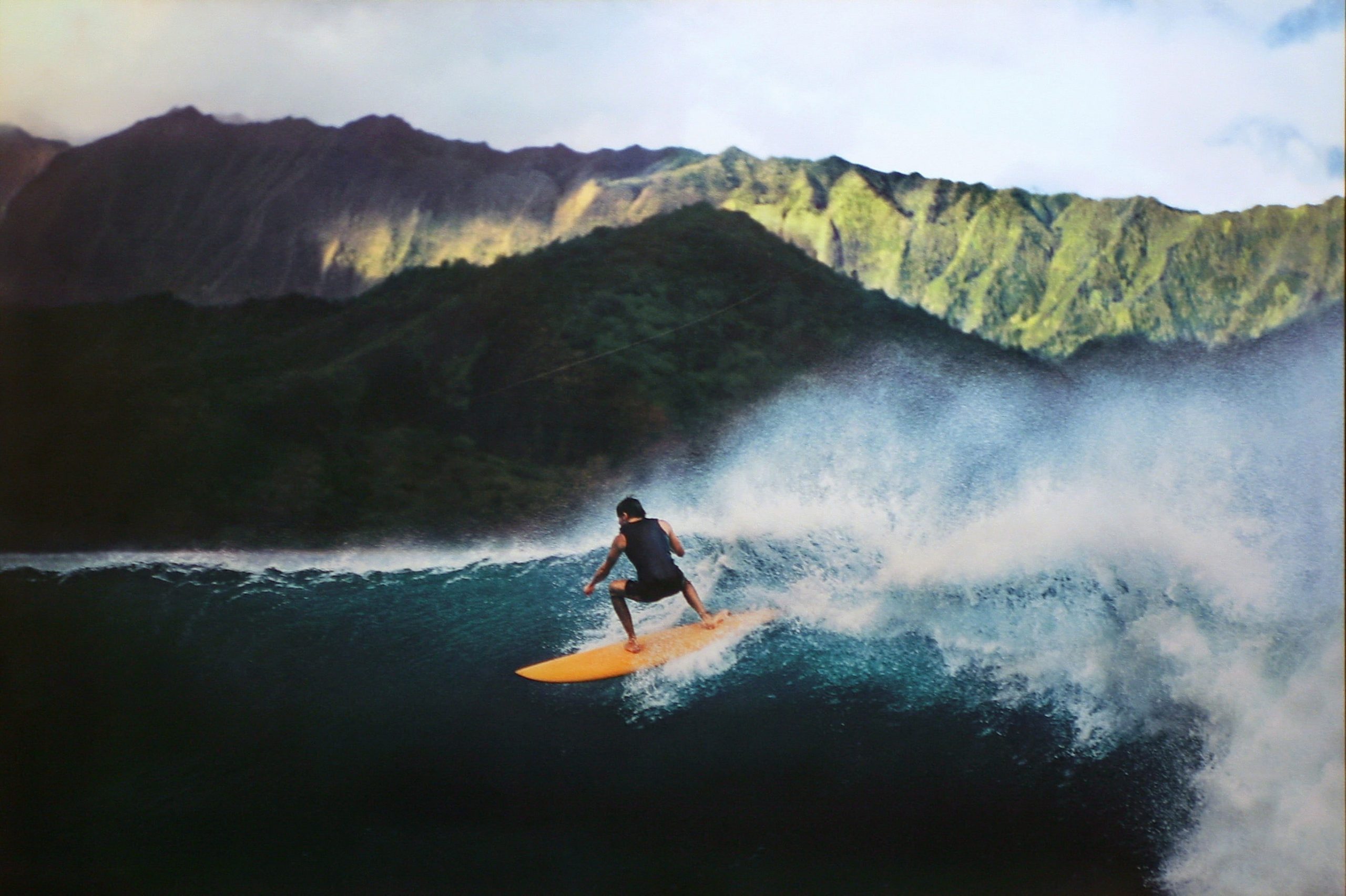 Man riding surf on sea near mountain, hawaii, hawaii, Surfer