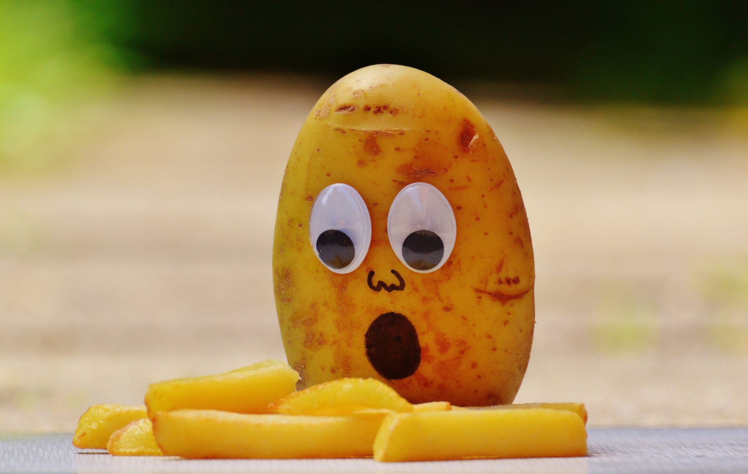 Funny potato wallpaper with googly eyes and French fries, potatoes, mourning