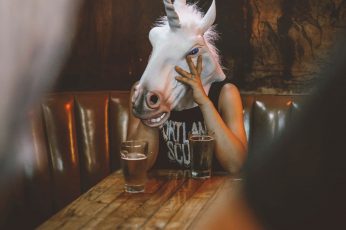 Wallpaper Person With Unicorn Head Sitting Near Table