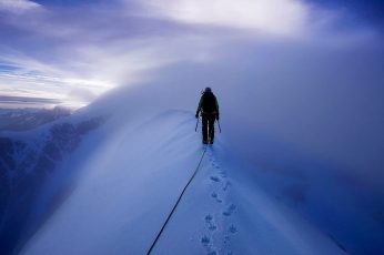 Wallpaper Person Walking On Top Of Snow Mountain Photograph