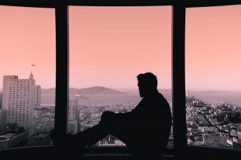 Wallpaper Silhouette Of Person Sitting On Building’s Windows